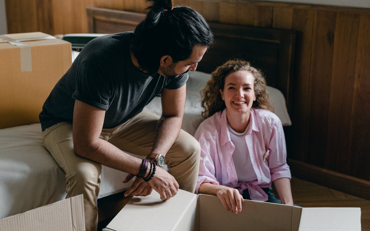 A couple unpacking boxes as they settle into a new home